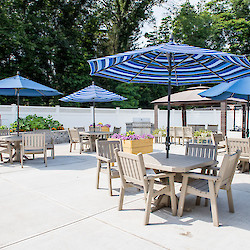 Patio with shaded tables and plants at 60 West